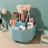 a desk with a blue container filled with makeup brushes