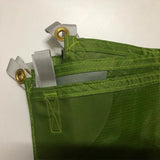 a green bag with two zippers on it