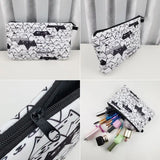 a white and black geometric pattern cosmetic bag with zipper closure