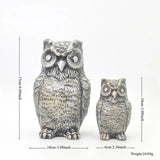 two owls figuris sitting on a white background