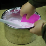 a person is putting a pink tissue into a metal container