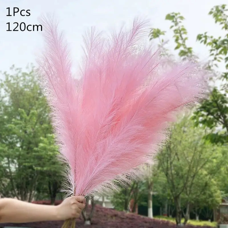 a person holding a pink feather in their hand