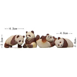 three stuffed pandas sitting on a white background