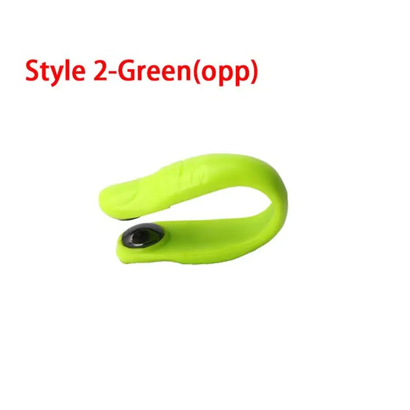 a green silicon wrist band with a black button