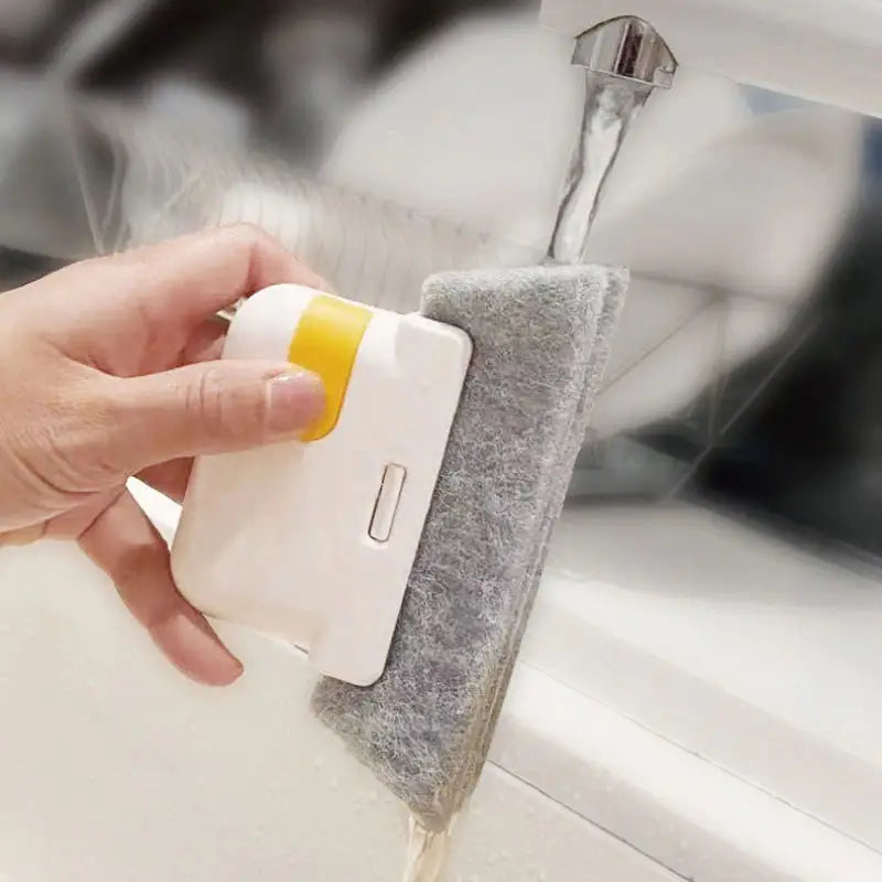 a person using a sponge to clean a sink