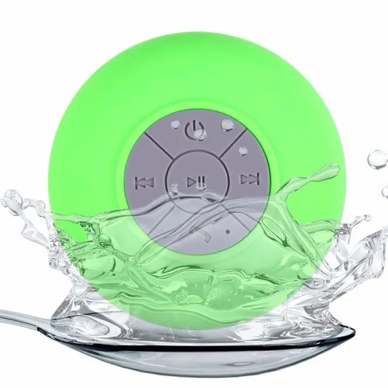 a green waterproof speaker floating in the water
