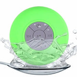 a green waterproof speaker floating in the water