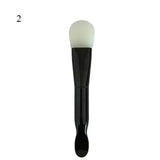 the face brush with a black handle