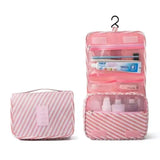 there is a pink bag with a toiletry bag and a toothbrush holder