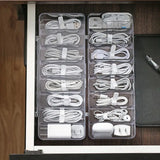a drawer with several cables and a charger