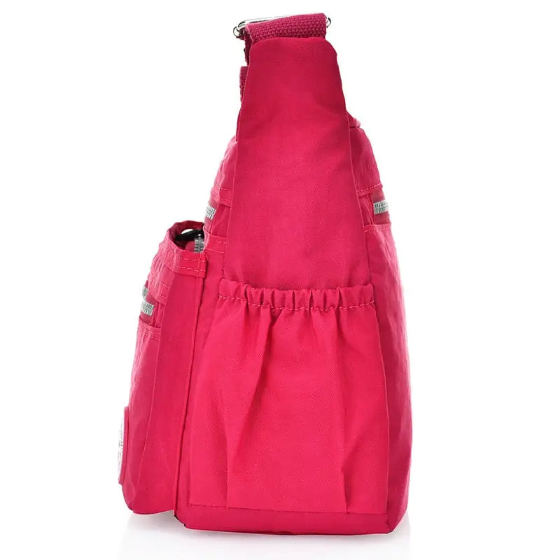 a close up of a pink bag with a bottle in it