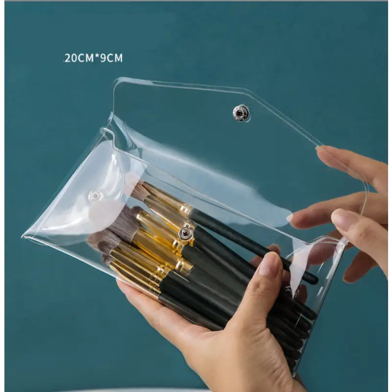 a person holding a clear bag with a pen in it