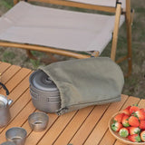 a picnic table with a bowl of strawberries and a cup of strawberries