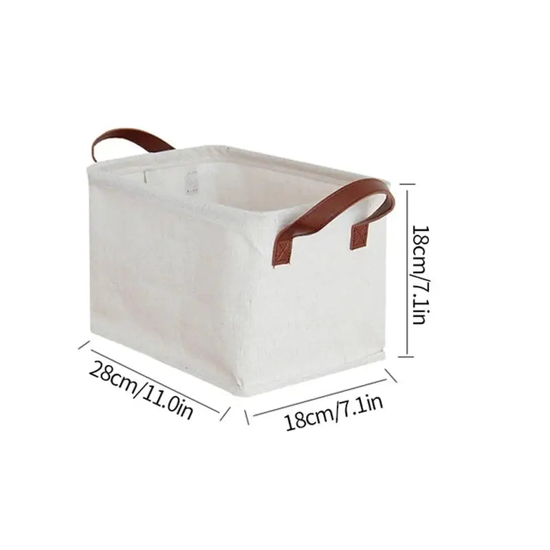 the white canvas storage box with brown leather handles