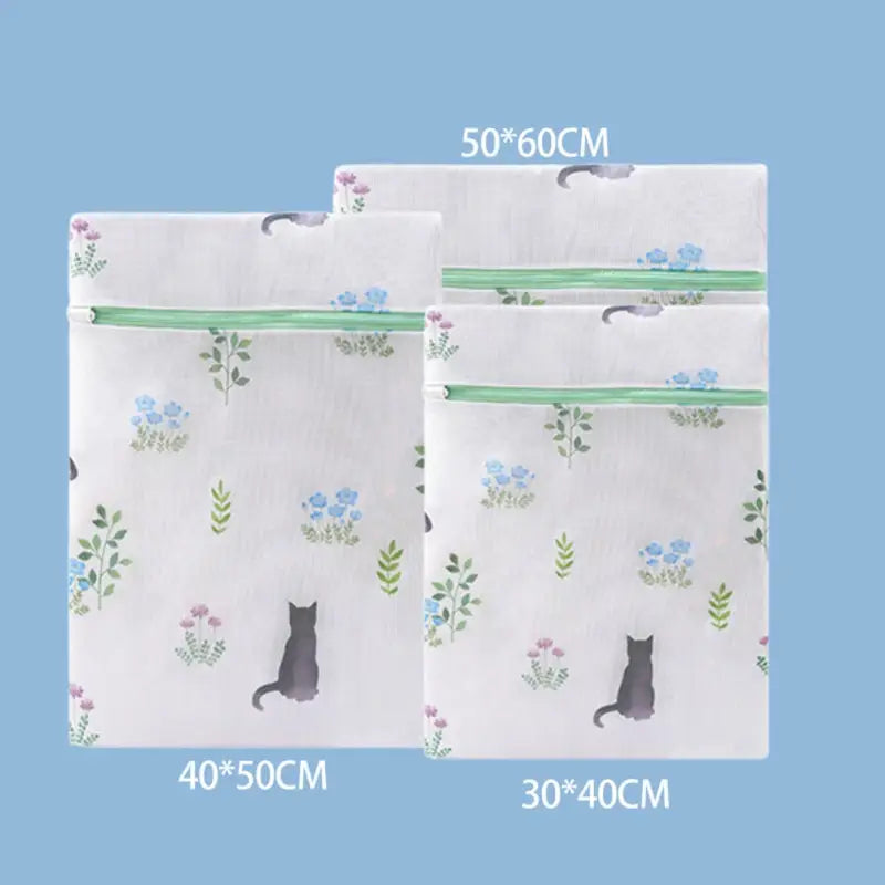 a pair of white tissue bags with a cat and flowers on them