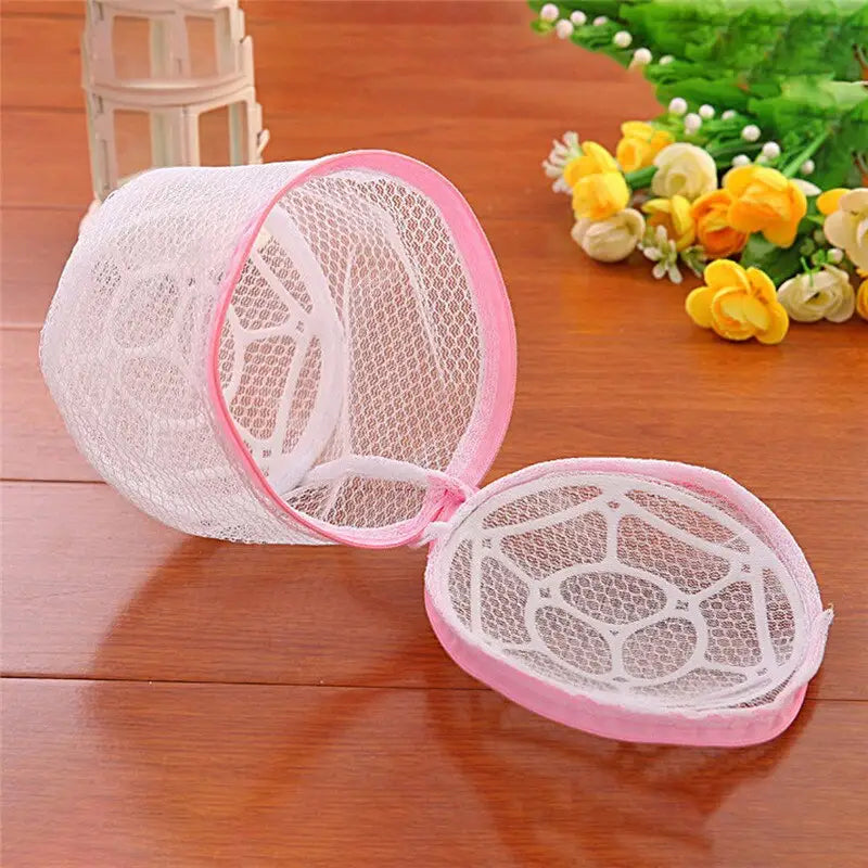 a small net with a pink handle on a wooden table