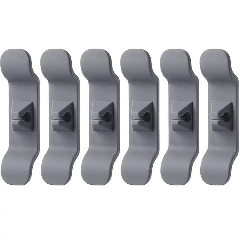 a set of five grey plastic wall hooks