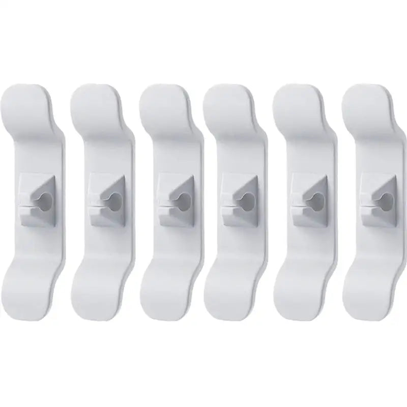 a set of five white plastic wall hooks