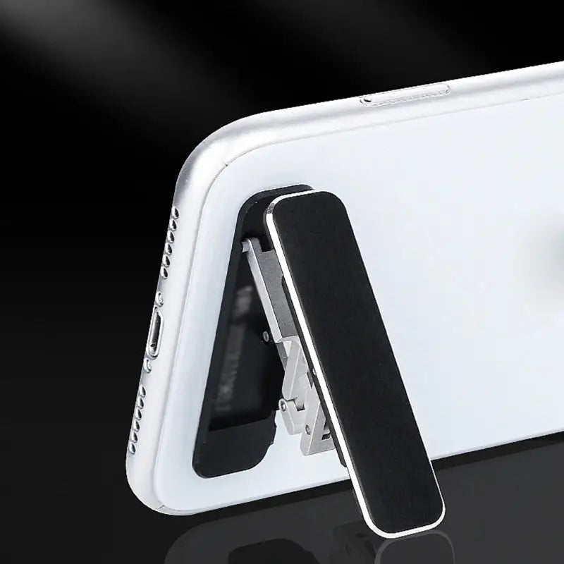 the iphone is shown with a white case and black stand