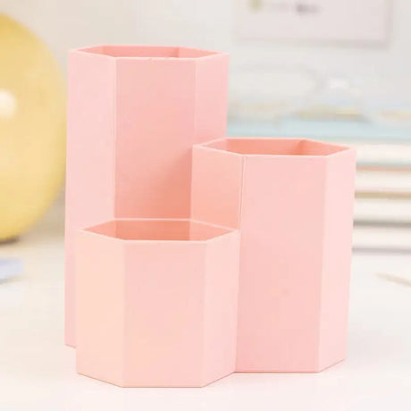 three pink vases on a white table