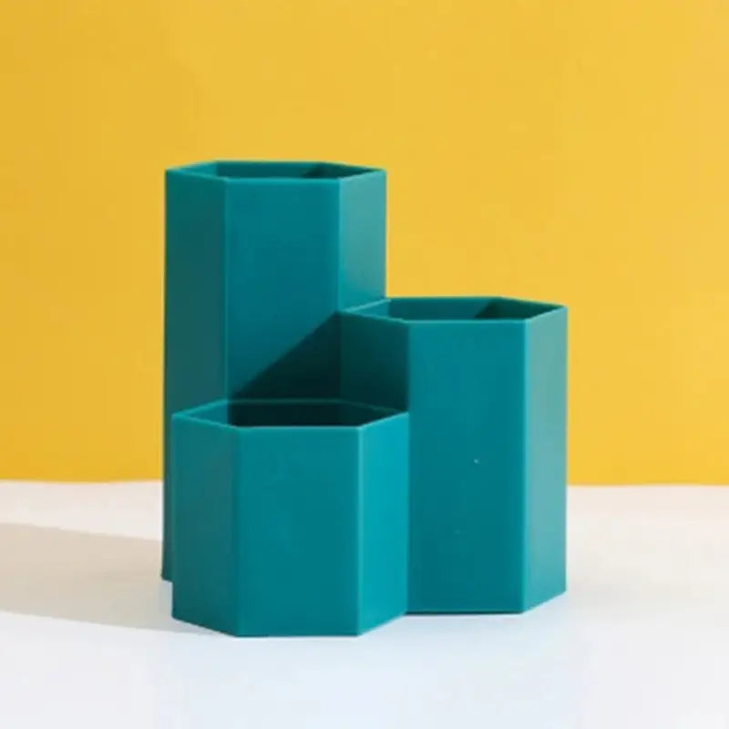 a green vase sitting on top of a white table