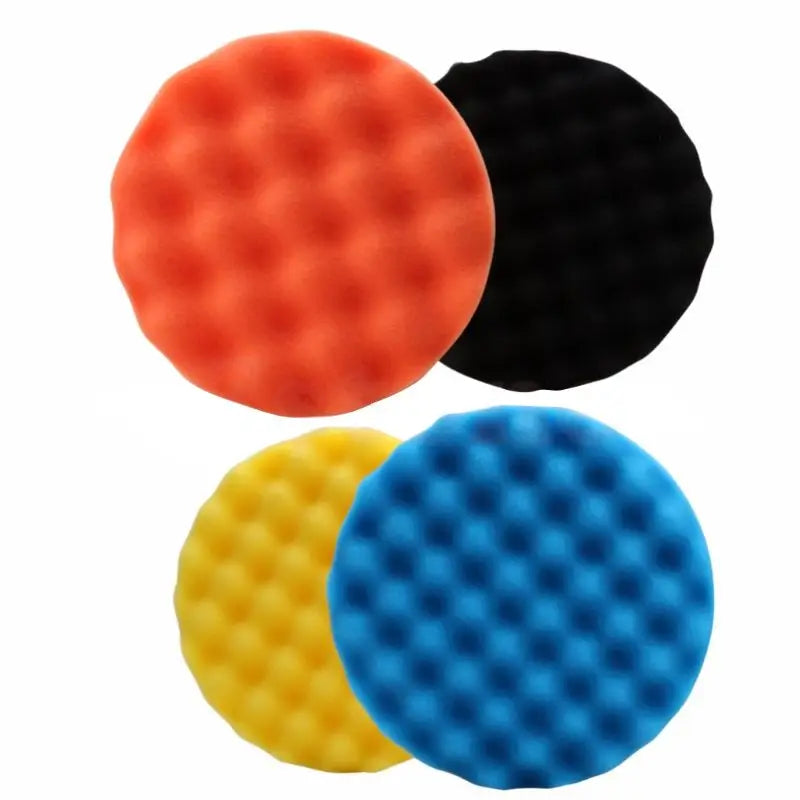 three different colored foam balls on a white background