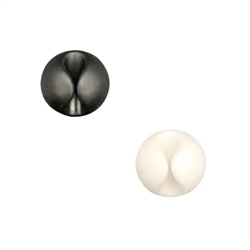 a pair of black and white ceramic knobs
