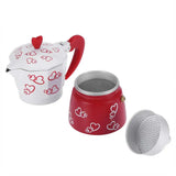 a red and white teapot with a heart design
