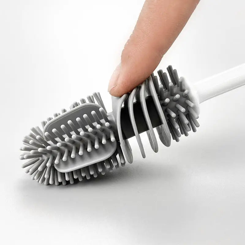 a hand holding a brush with a white handle