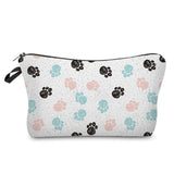 a white cosmetic bag with a pattern of paws and paw prints