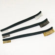three brushes with gold and black handles