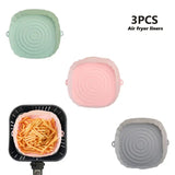 three different colors of air fryer lids with a frying pan
