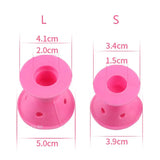 two pink plastic spools with holes and holes on them