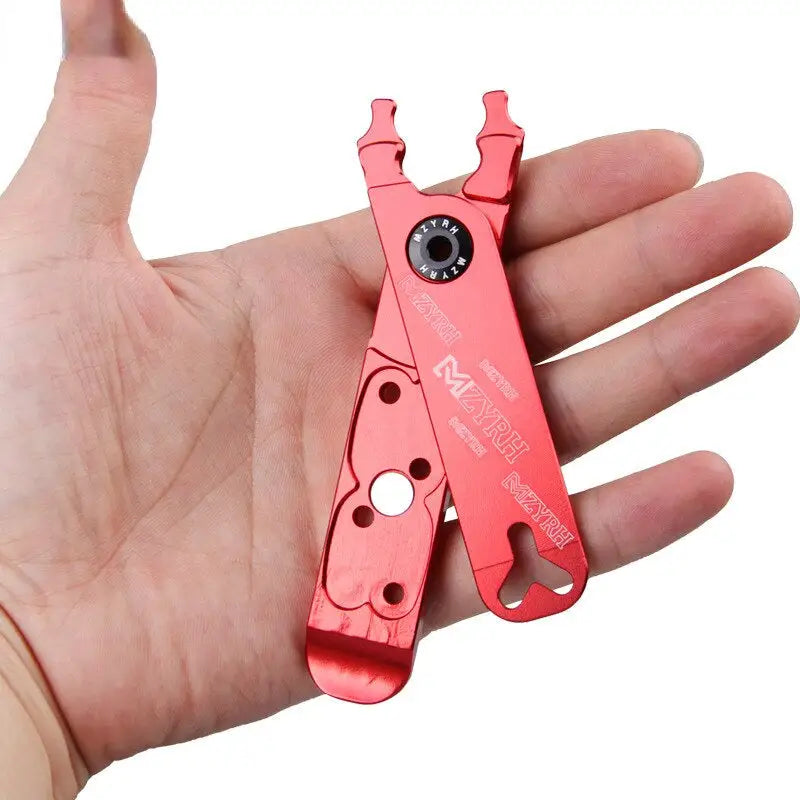 a hand holding a red tool with a hole in it