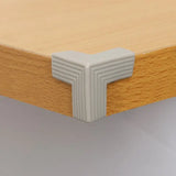 a close up of a wooden shelf with a white square shaped corner