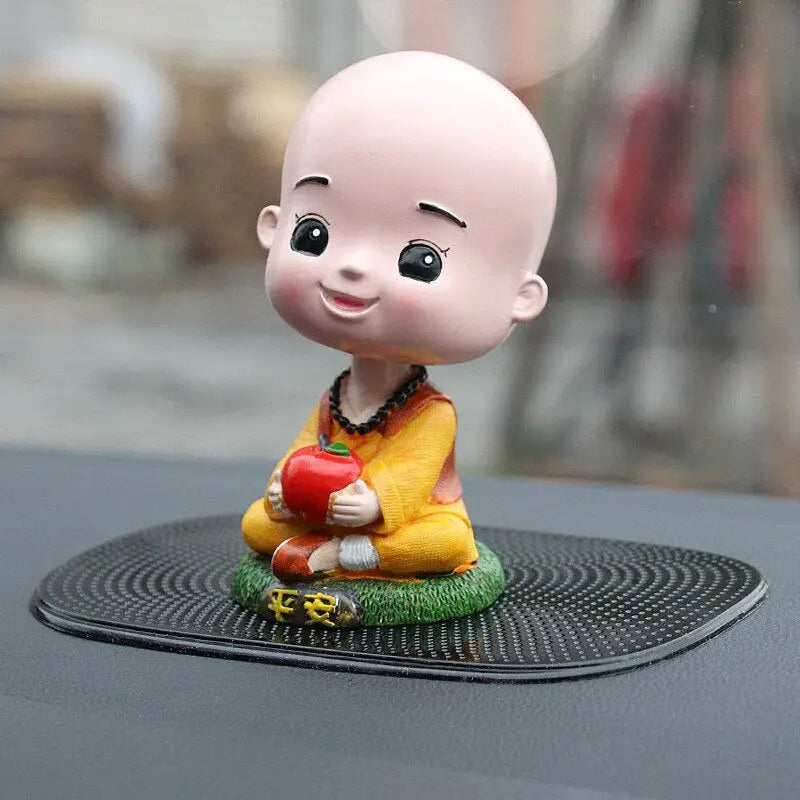 a small figurin sitting on top of a car
