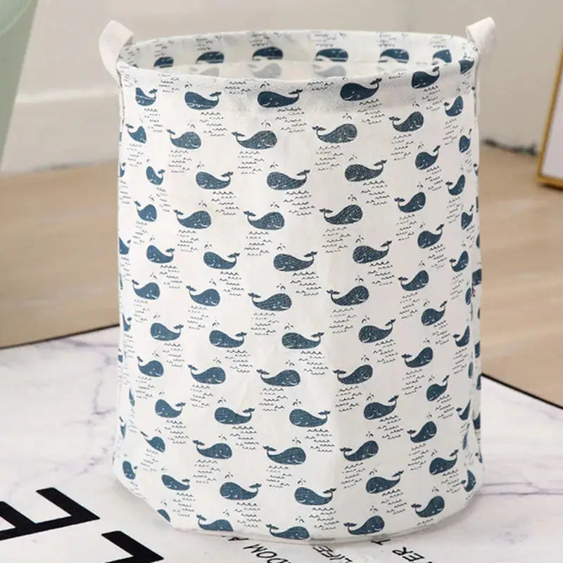 a blue whale pattern laundry bag on a white marble table