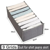 the grey fabric storage box with six folded folded towels