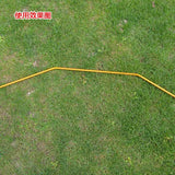 a yellow hose is laying on the grass