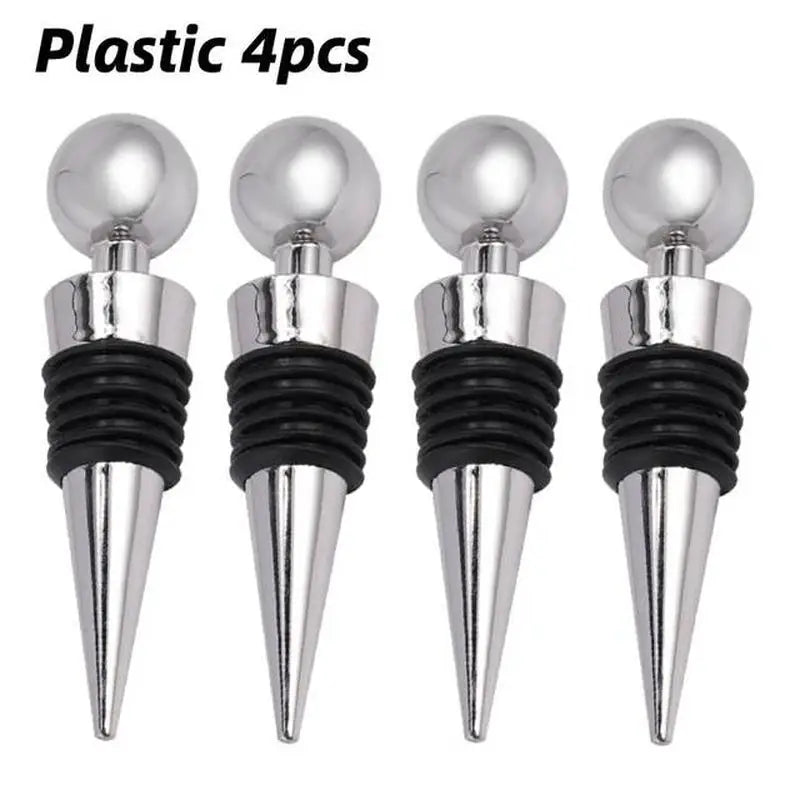 three silver wine stoppers with black plastic tops and a white background