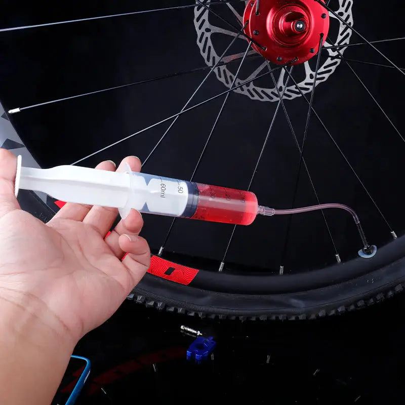 a person is using a bike tire gauge to check the tire pressure