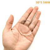 a hand holding a clear glass ball