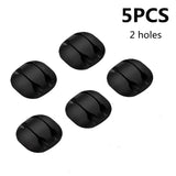 a close up of four black plastic knobs on a white background