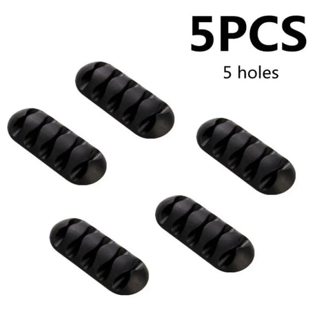 five black plastic pill caps with a white background