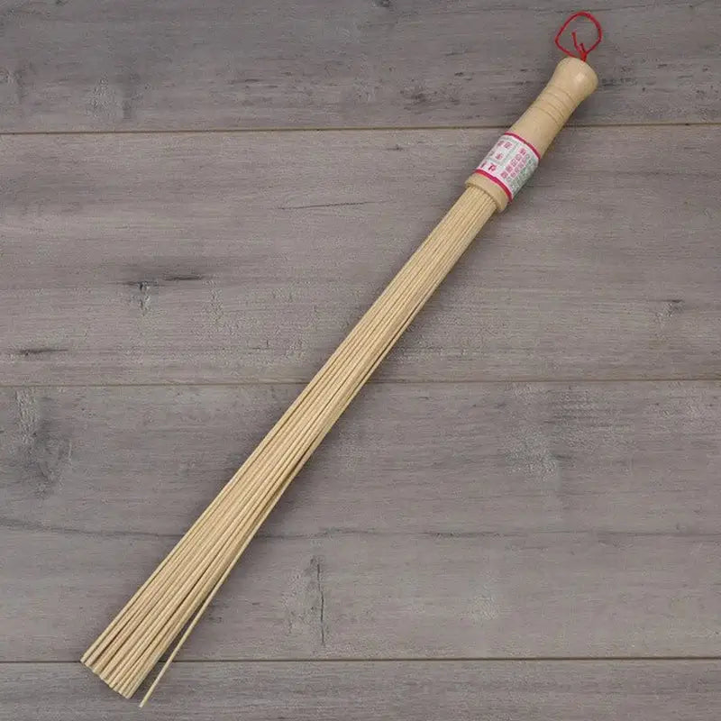 a wooden incense stick with a red string