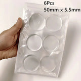 a hand holding a clear plastic container with six small white circles