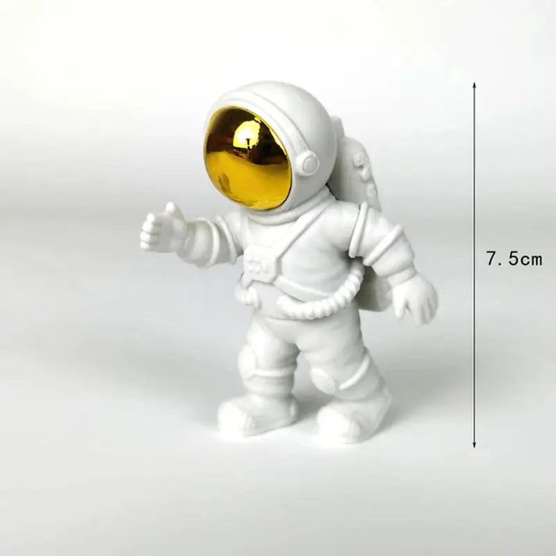 a small toy astronaut with a gold helmet