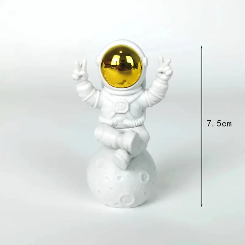 a white and gold astronaut fig with a gold sphere