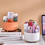 a desk with a laptop, a cup and a pen holder