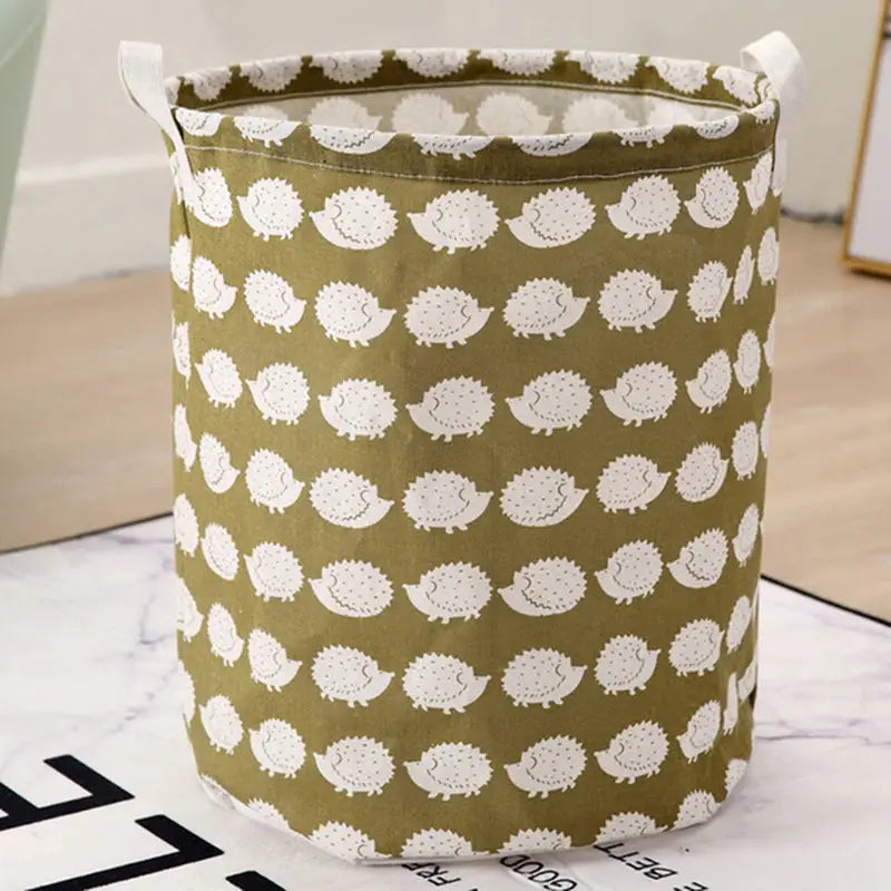 a green fabric storage bag with white hedges on it